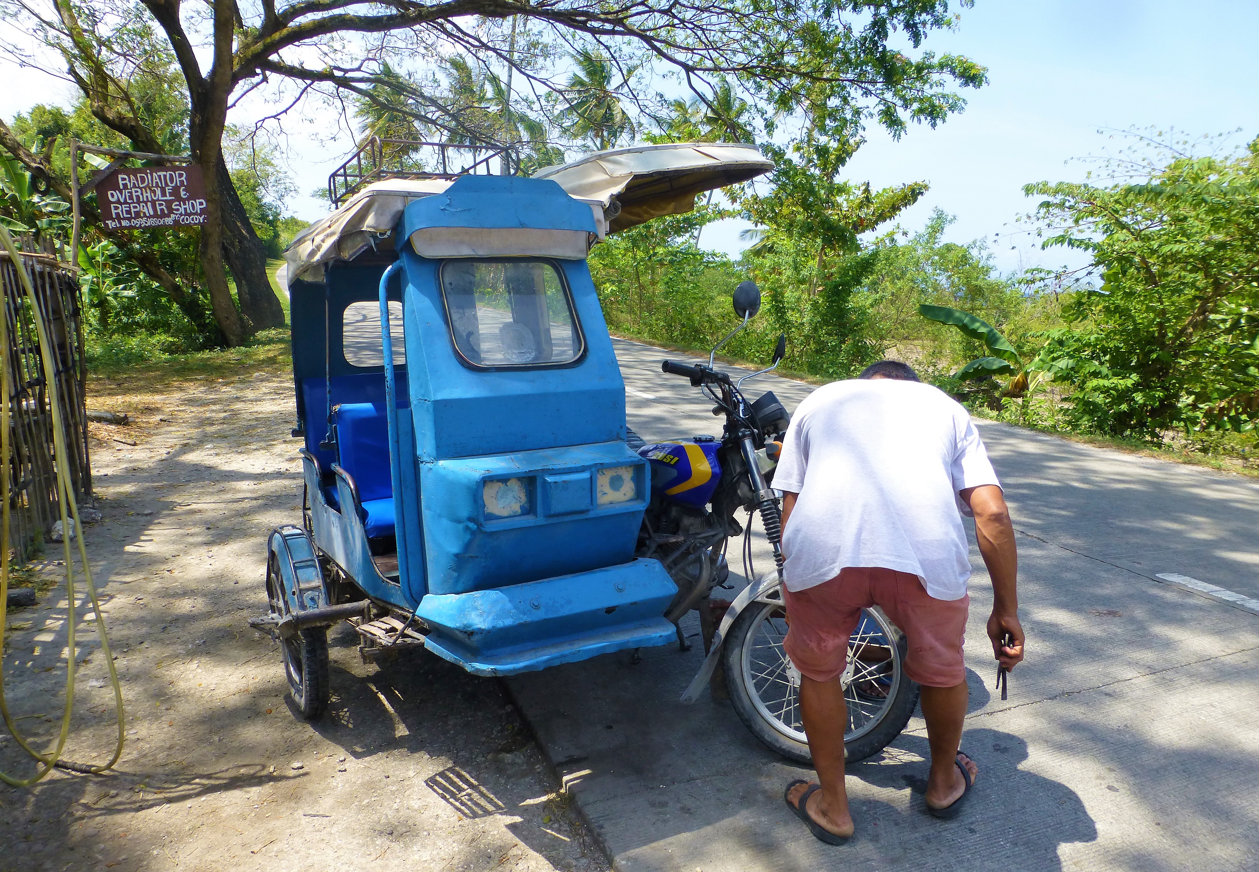 Having a flat tire with your tricycle, Moalboal - Phillipines Having a flat tire with your tricycle, Moalboal - Phillipines