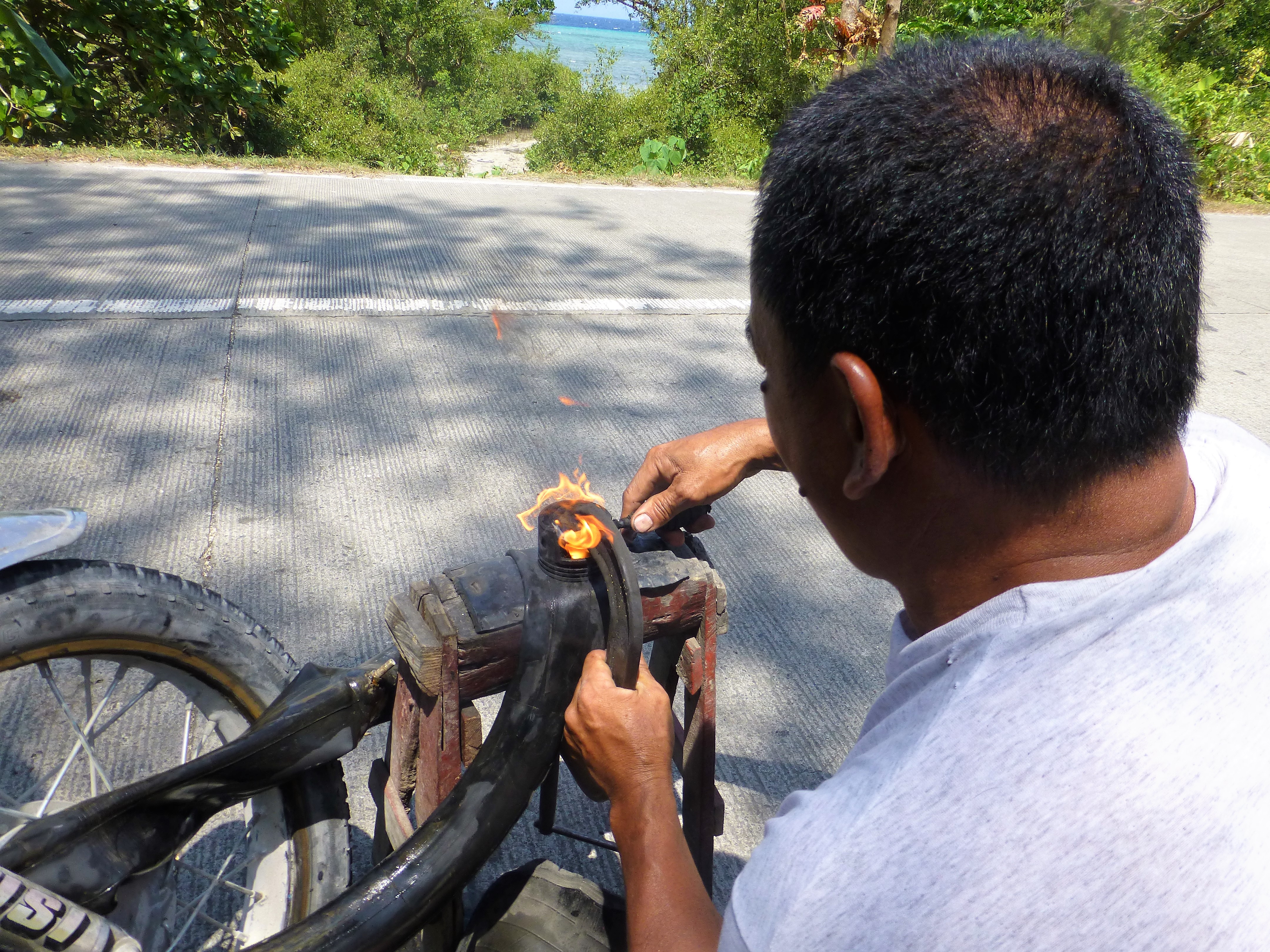 Having a flat tire with your tricycle, Moalboal - Phillipines Having a flat tire with your tricycle, Moalboal - Phillipines