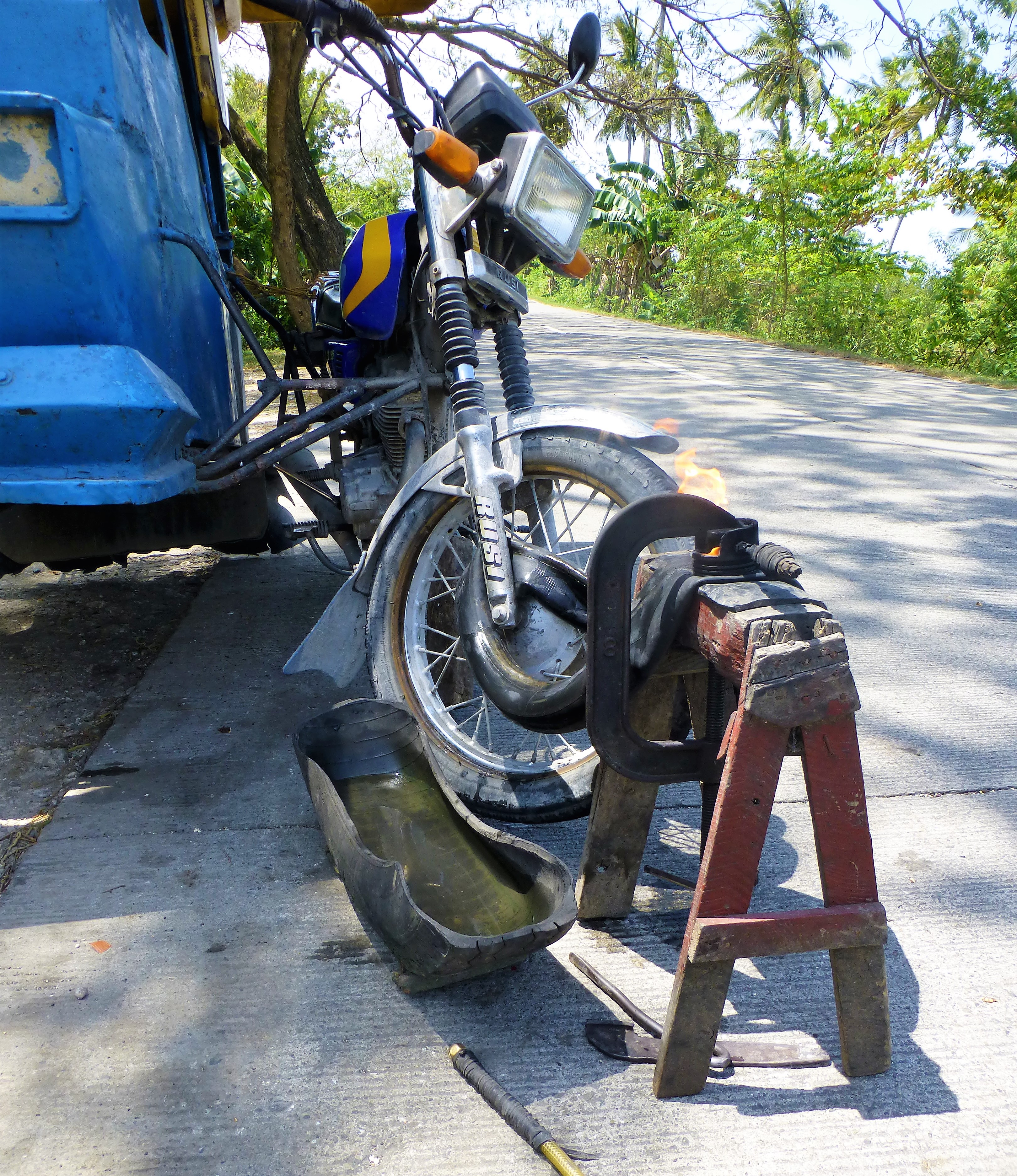 Having a flat tire with your tricycle, Moalboal - Phillipines Having a flat tire with your tricycle, Moalboal - Phillipines